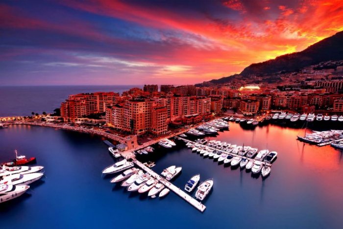 Monaco features luxury yachts lined up at the harbor