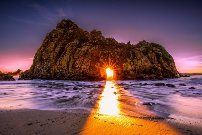 Pfeiffer Beach in California is characterized by its soft, sandy-purple color