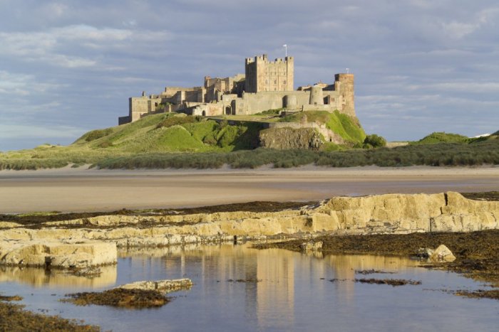 An impressive historic castle set on top of a throne-like volcanic eruption on the Northumberland coast