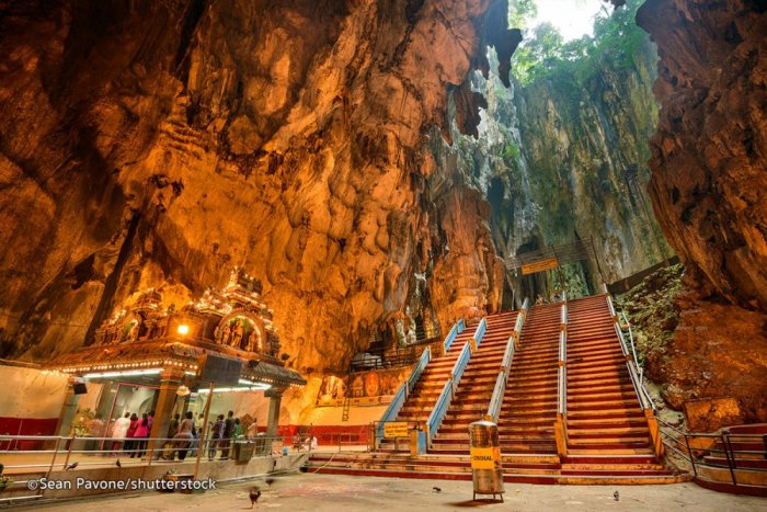 Batu Caves is a series of Hindu caves and temples that are found in the heart of a limestone hill
