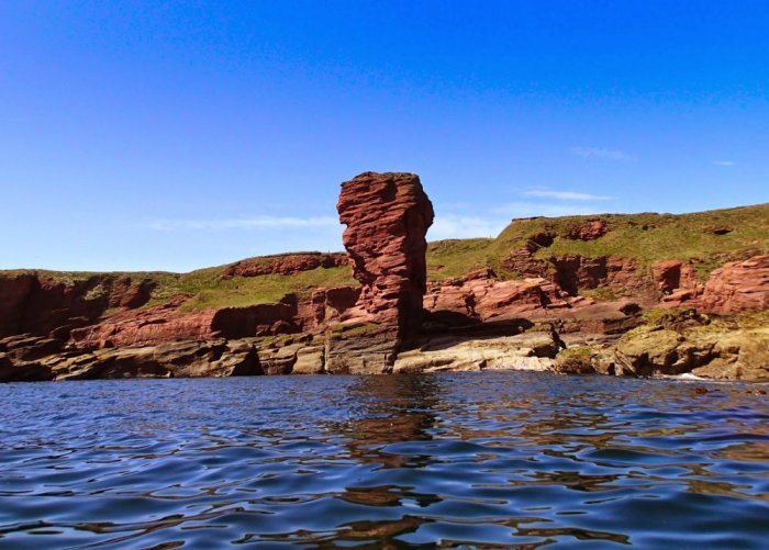 Coast of Angus, tourists can see the pink sandstones along the beach