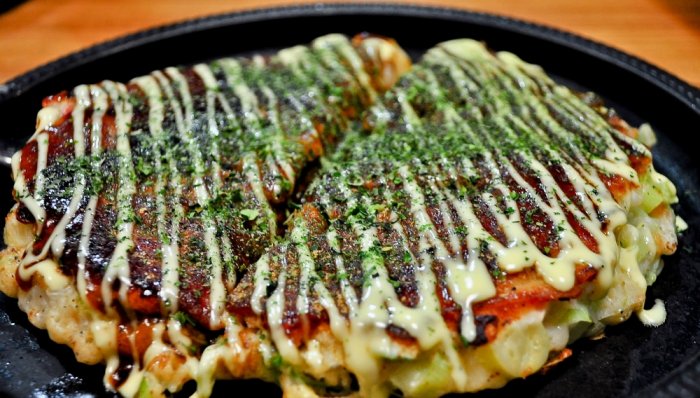 Okonomiyaki is a delicious Japanese pastry stuffed with a mixture of meat and vegetables