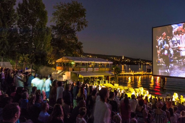 Zurich residents and visitors enjoy outdoor movies on the shores of Lake Zurich during the summer