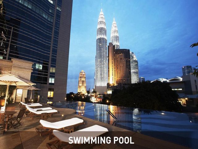 An outdoor pool with a view and deck chairs is ideal at Ambiana Kuala Lumpur Hotel