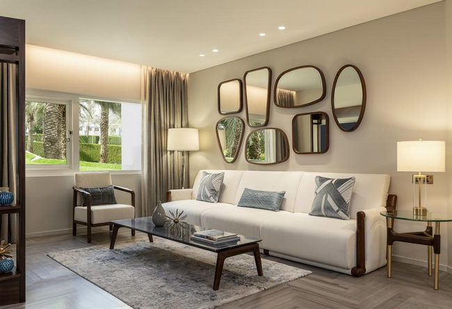An elegant seating area with garden views in the rooms of Le Meridien Dubai Hotel