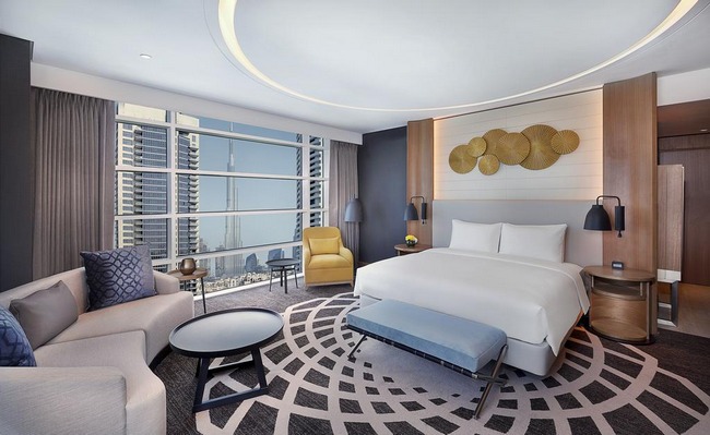 A very comfortable large bed and a wonderful sitting area with city views at DoubleTree by Hilton Dubai