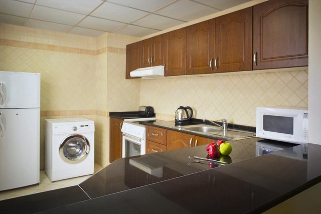 Inside Crystal Time Hotel Apartments Al Barsha offer fully equipped kitchens.