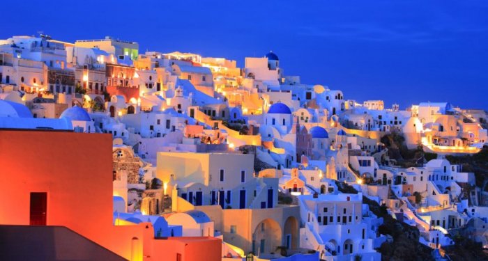 The white-built village of Oia is located on the coast at the northern edge of Santorini