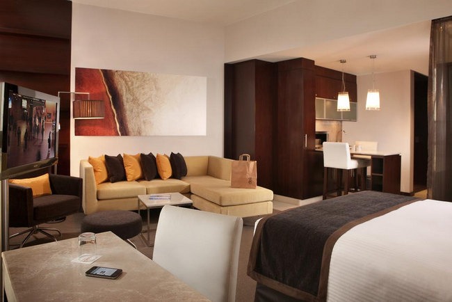Three-star hotels in Sharjah have rooms with comfortable seating and a distinct work area