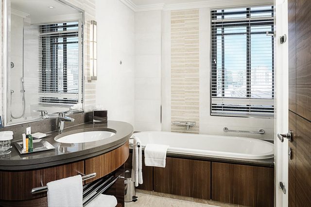 The marble bathrooms at Hilton London Paddington feature a large window that helps in natural light
